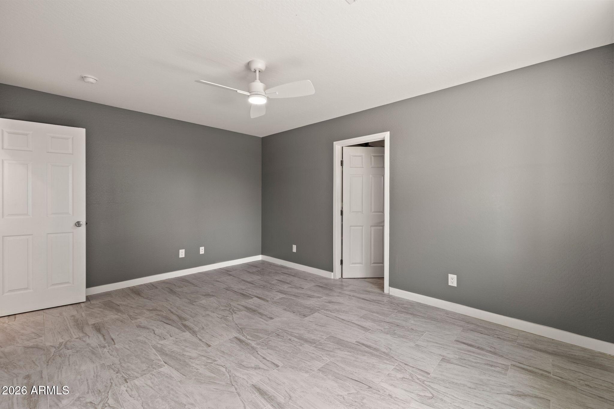 17933 East Bob White Road Mayer, AZ 86333 - Photo 21 of 30 an empty room with closet and a ceiling fan