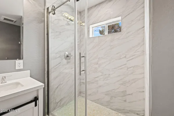 a bathroom with a shower and a sink