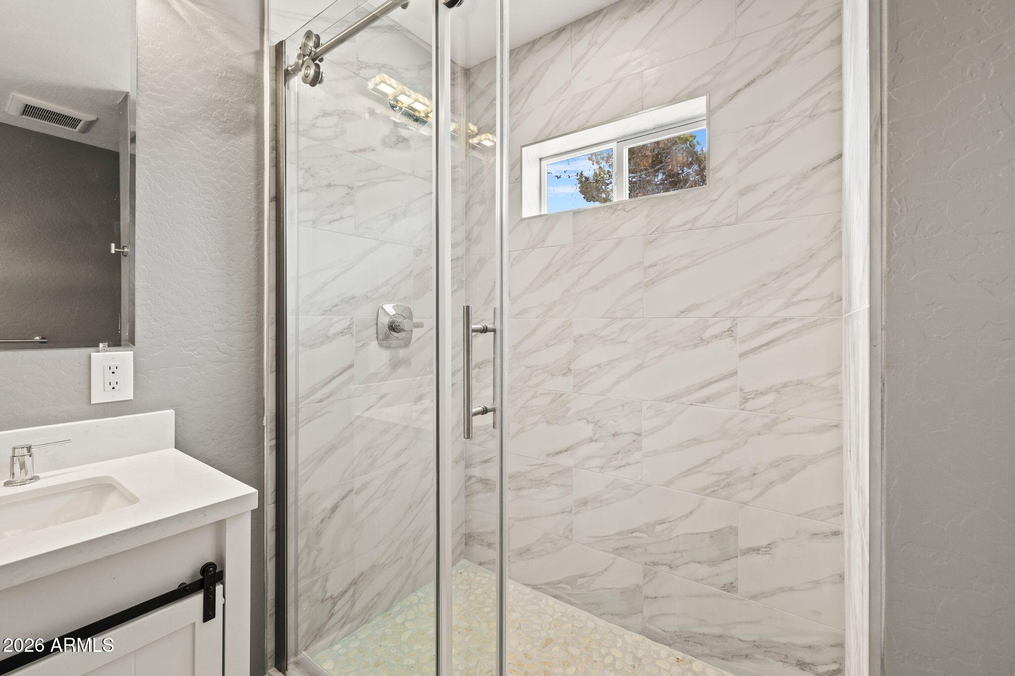 17933 East Bob White Road Mayer, AZ 86333 - Photo 25 of 30 a bathroom with a shower and a sink