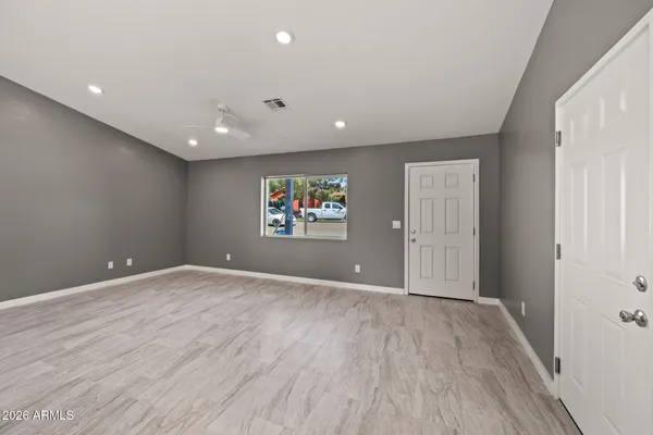 a view of an empty room with wooden floor