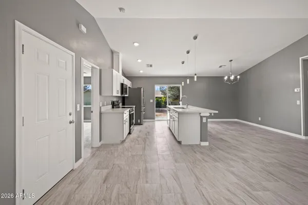a kitchen with a sink and wooden floor