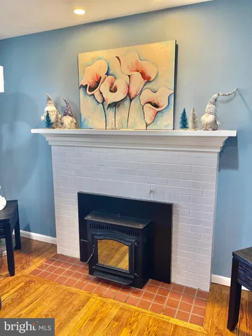 a living room with a fireplace and wooden floor