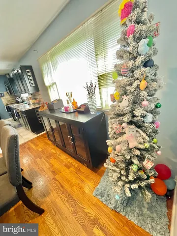 a kitchen with stainless steel appliances kitchen island granite countertop a refrigerator a stove a sink and dining table