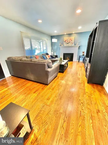 a living room with fireplace furniture and a flat screen tv