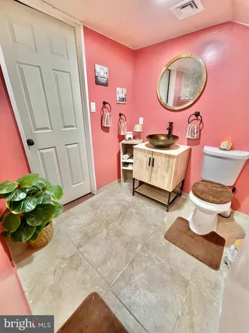 a view of a big house with a big yard and large tree