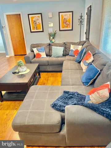 a living room with rug couches and painting on the wall