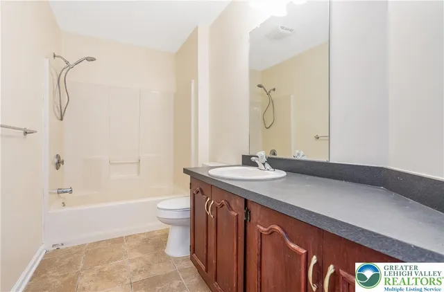 a bathroom with a sink and mirror with toilet