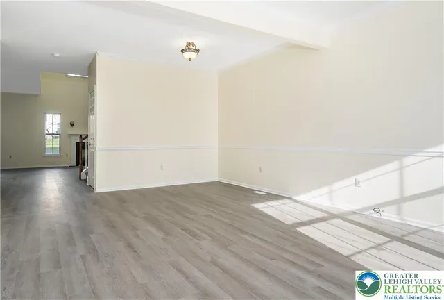 a view of a livingroom with an empty space and a window