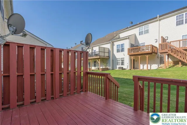 a view of a house with wooden deck
