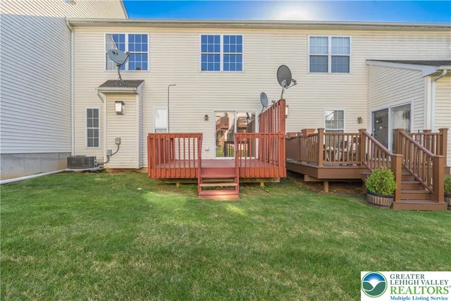 a view of a house with backyard and a garden