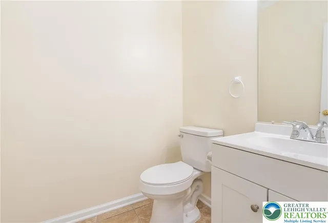 a white toilet sitting next to a white sink