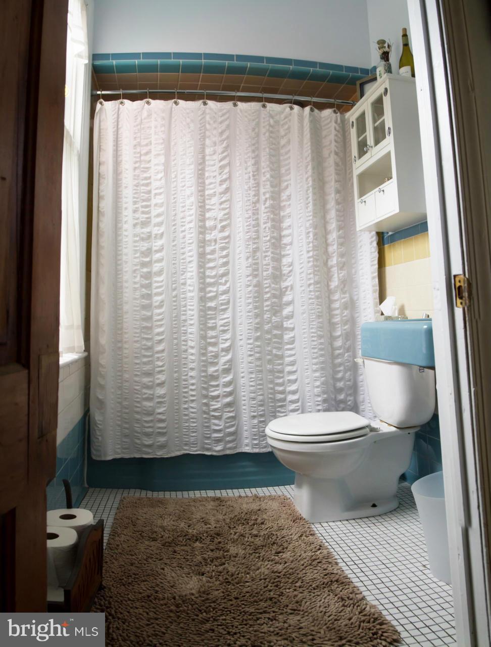 5719 Berwyn Road Berwyn Heights, MD 20740 - Photo 14 of 30 a bathroom with a toilet a sink and a window