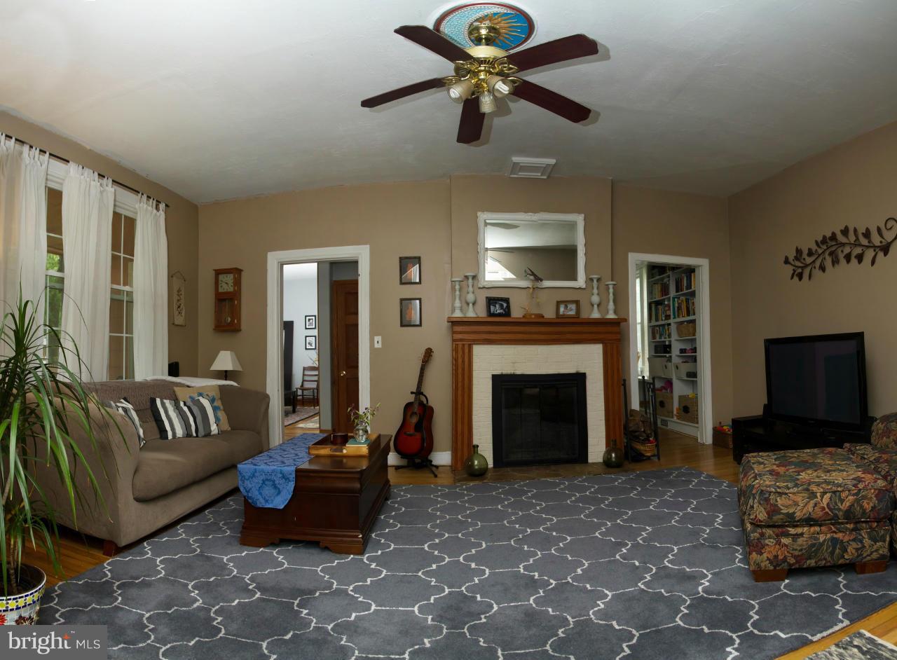 5719 Berwyn Road Berwyn Heights, MD 20740 - Photo 19 of 30 a living room with furniture a flat screen tv and a fireplace