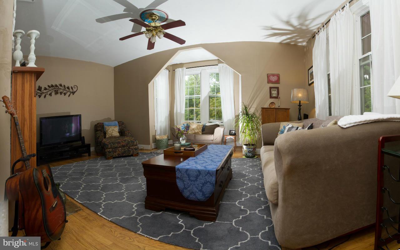 5719 Berwyn Road Berwyn Heights, MD 20740 - Photo 20 of 30 a living room with fireplace furniture and a large window
