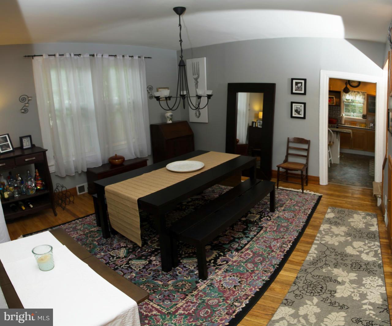 5719 Berwyn Road Berwyn Heights, MD 20740 - Photo 21 of 30 a room with a table chairs and a wooden floor