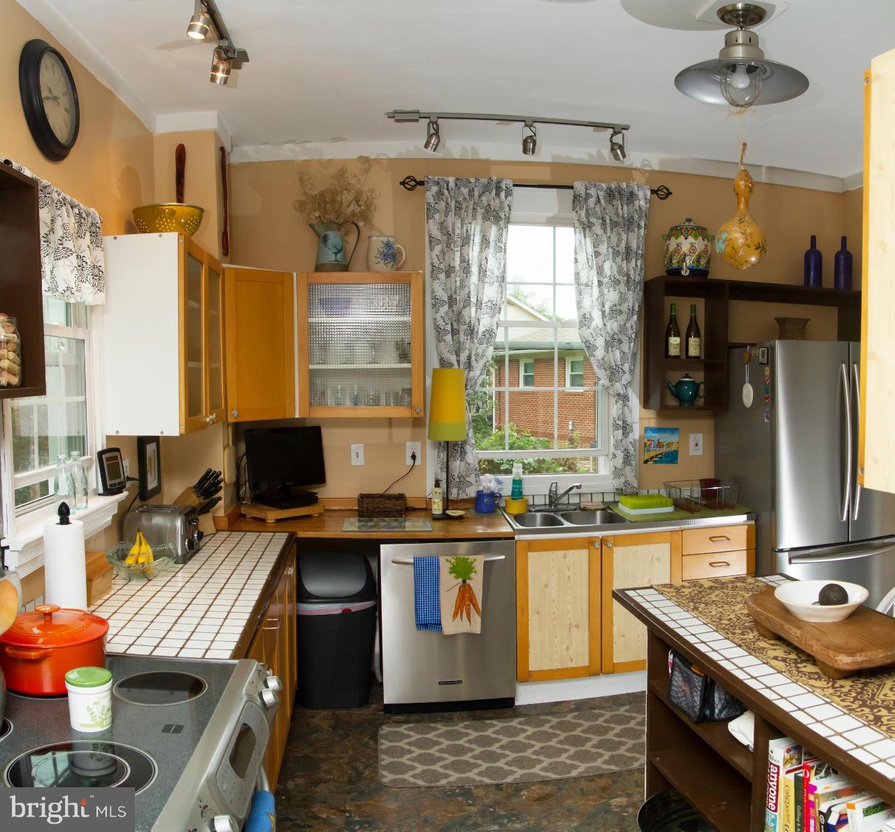 5719 Berwyn Road Berwyn Heights, MD 20740 - Photo 26 of 30 a kitchen with a stove a sink and a refrigerator