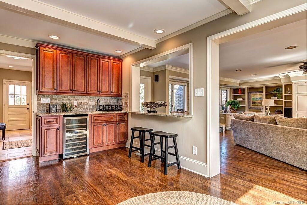 6127 Glenridge Road Charlotte, NC 28211 - Photo 12 of 24 a kitchen with a table chairs refrigerator and cabinets