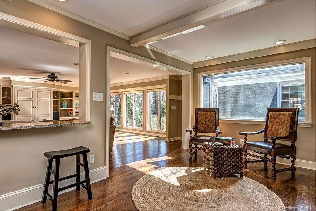 6127 Glenridge Road Charlotte, NC 28211 - Photo 13 of 24 a living room with furniture a flat screen tv and a floor to ceiling window