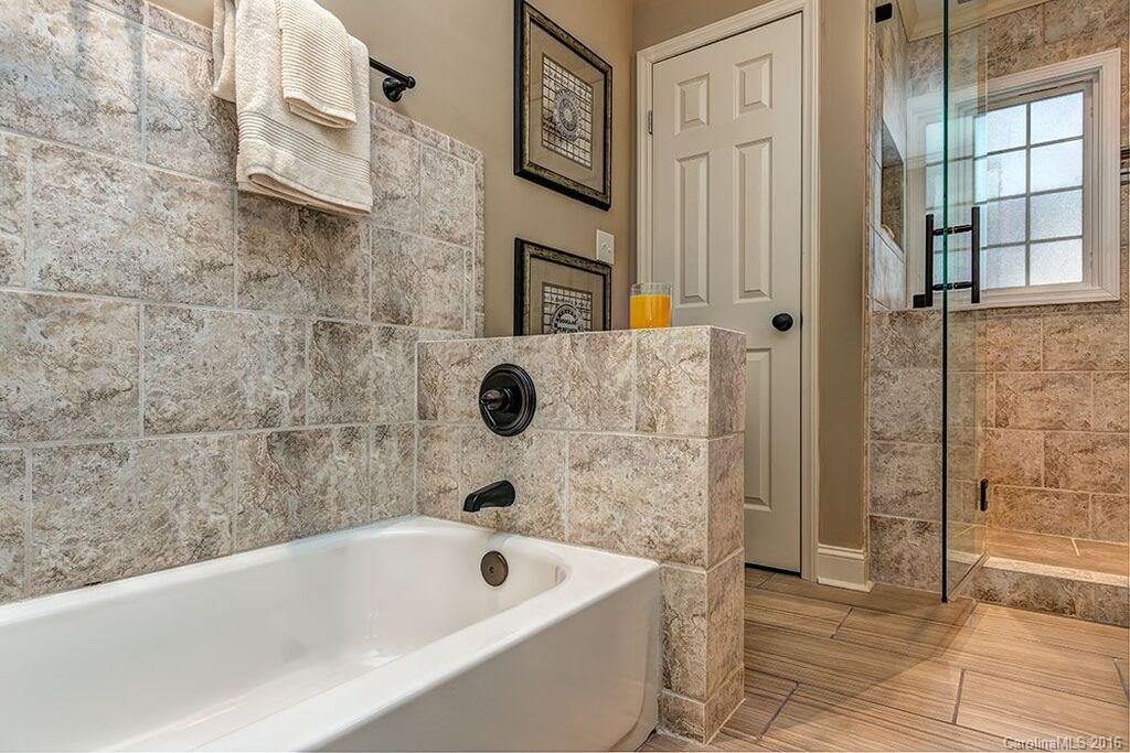6127 Glenridge Road Charlotte, NC 28211 - Photo 19 of 24 a bathroom with a tub