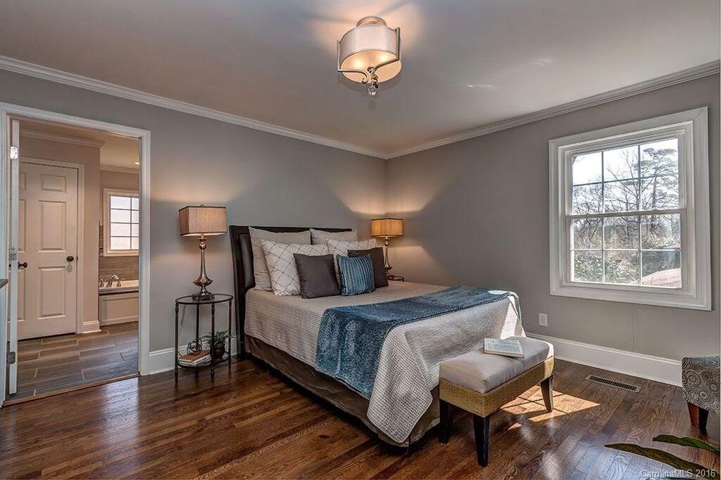 6127 Glenridge Road Charlotte, NC 28211 - Photo 22 of 24 a bedroom with a bed and wooden floor