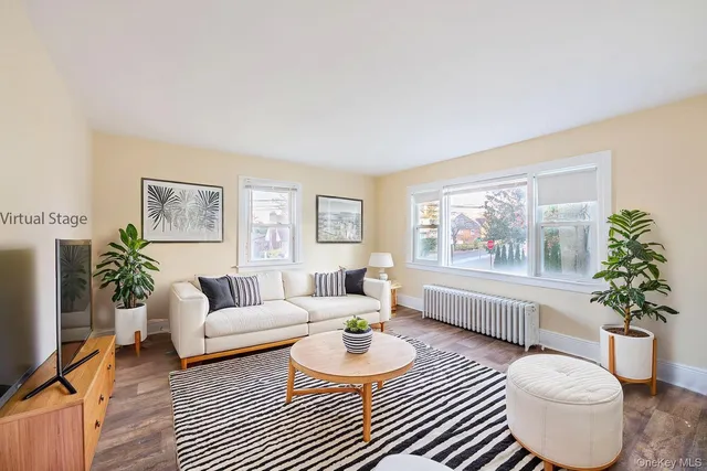 a living room with furniture a table and a large window