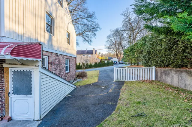 a view of a backyard with brick wall