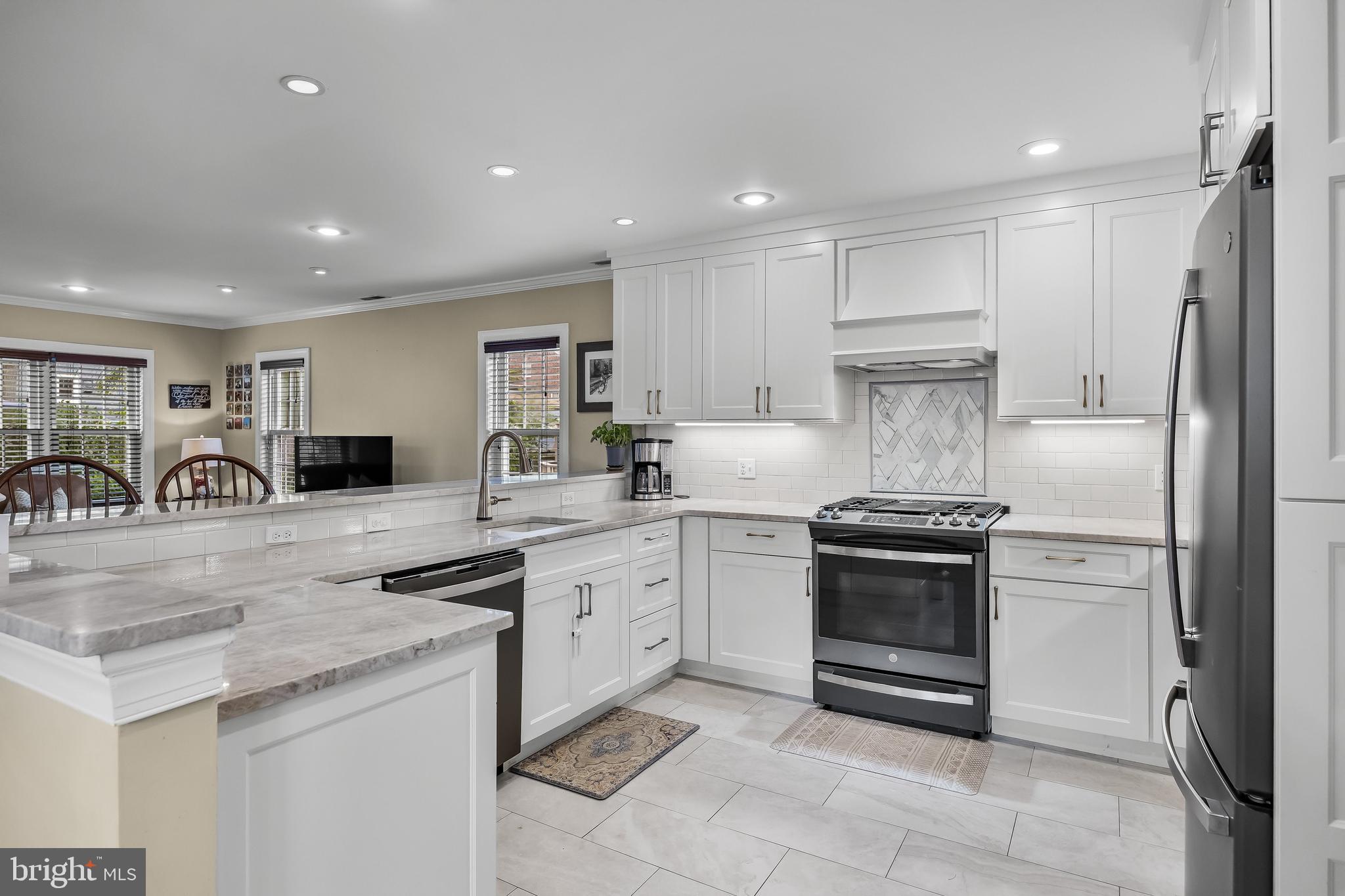 31 Wesley Avenue Cherry Hill, NJ 08002 - Photo 11 of 52 a kitchen with granite countertop a refrigerator and a stove top oven