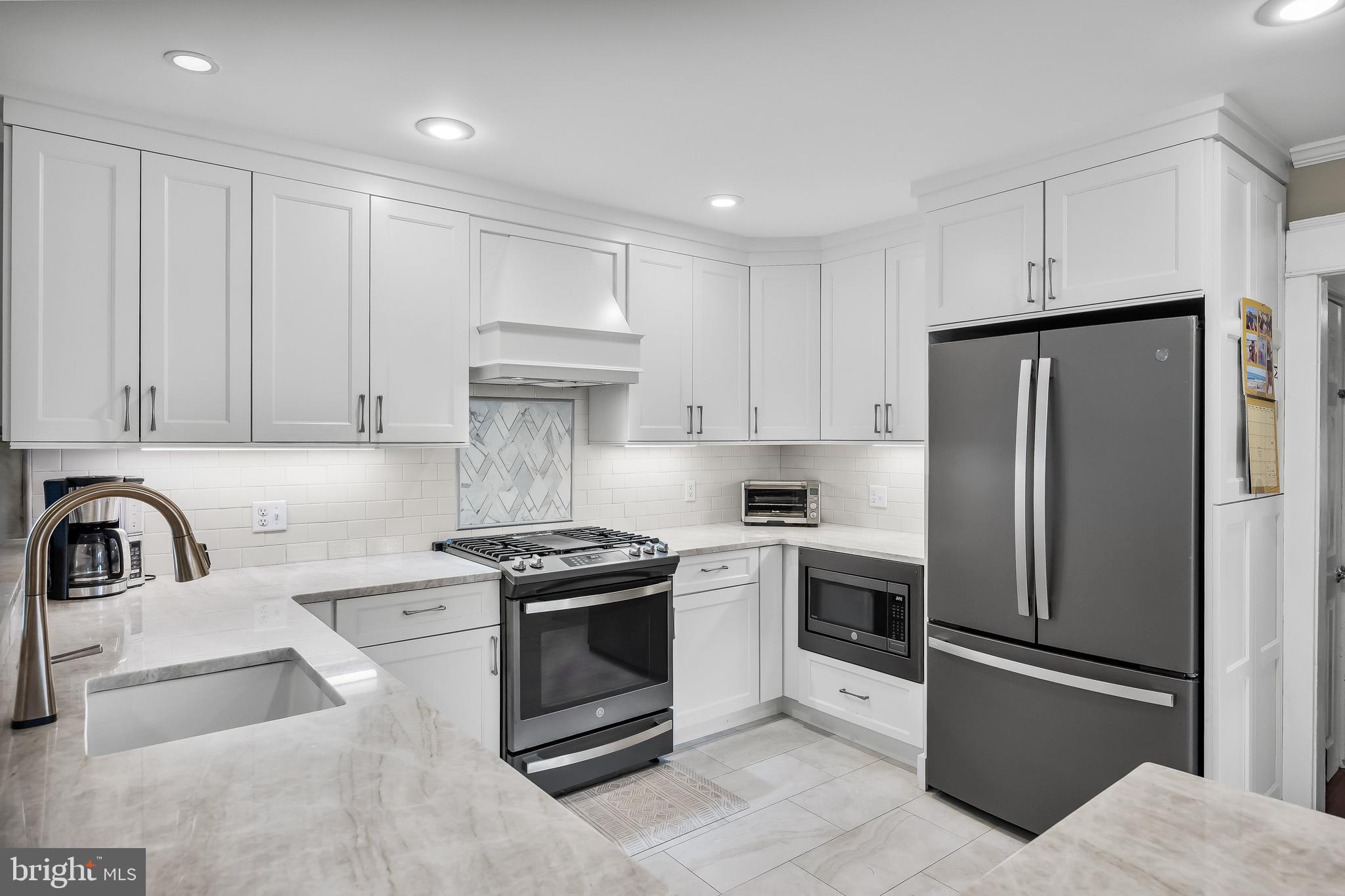 31 Wesley Avenue Cherry Hill, NJ 08002 - Photo 13 of 52 a kitchen with stainless steel appliances granite countertop a sink stove and refrigerator