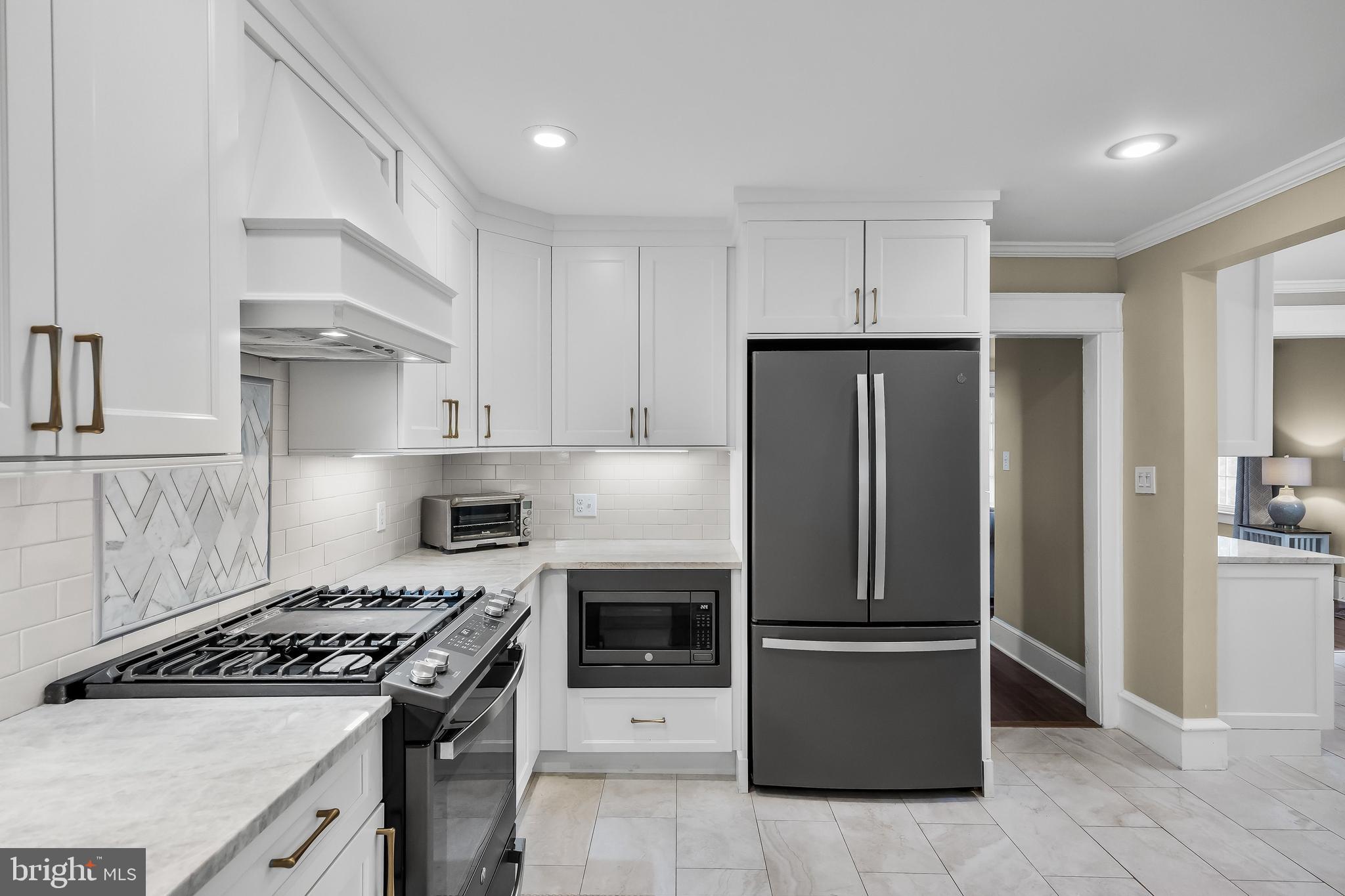 31 Wesley Avenue Cherry Hill, NJ 08002 - Photo 14 of 52 a kitchen with cabinets and stainless steel appliances