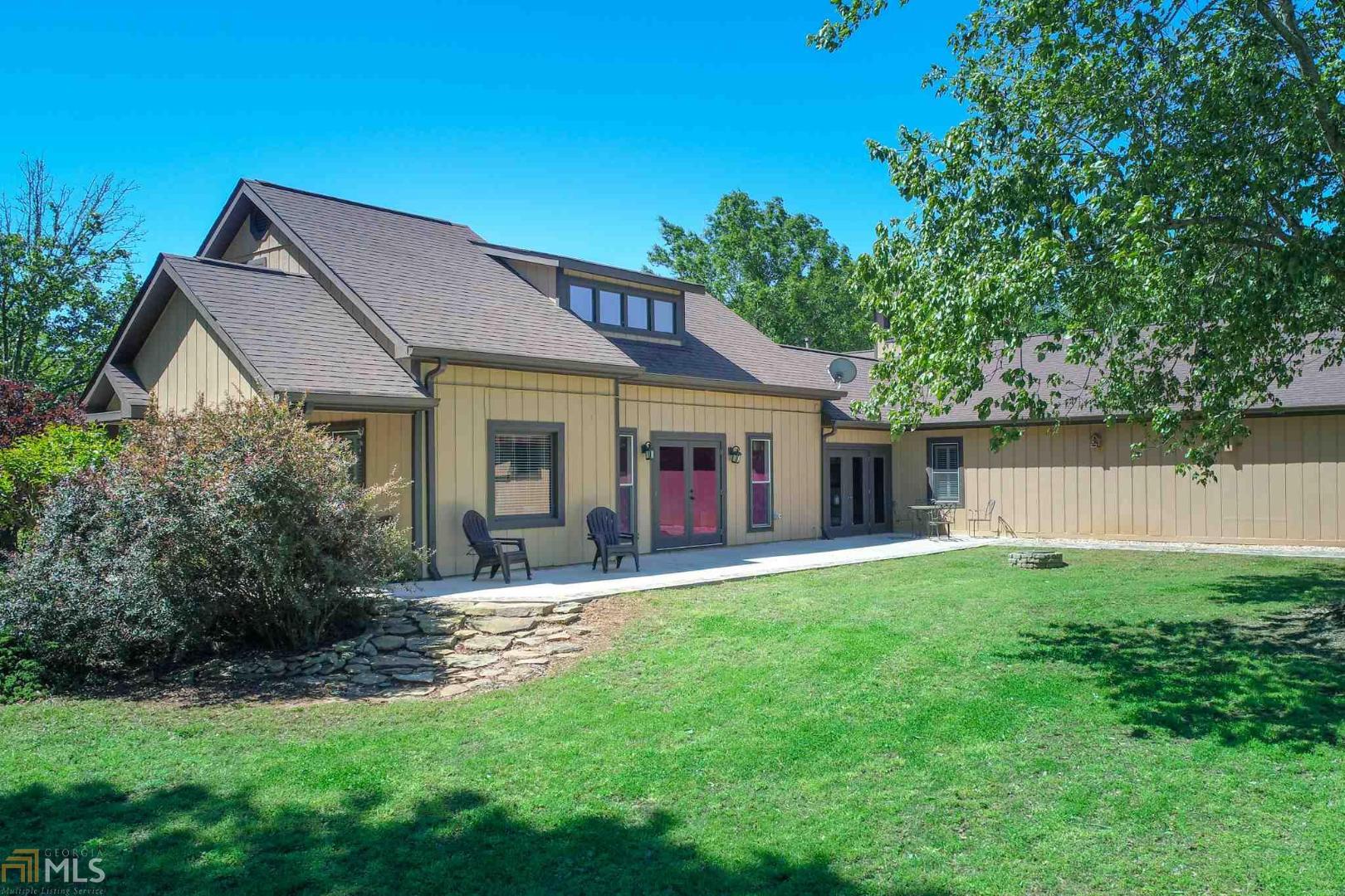 a front view of a house with a garden and yard