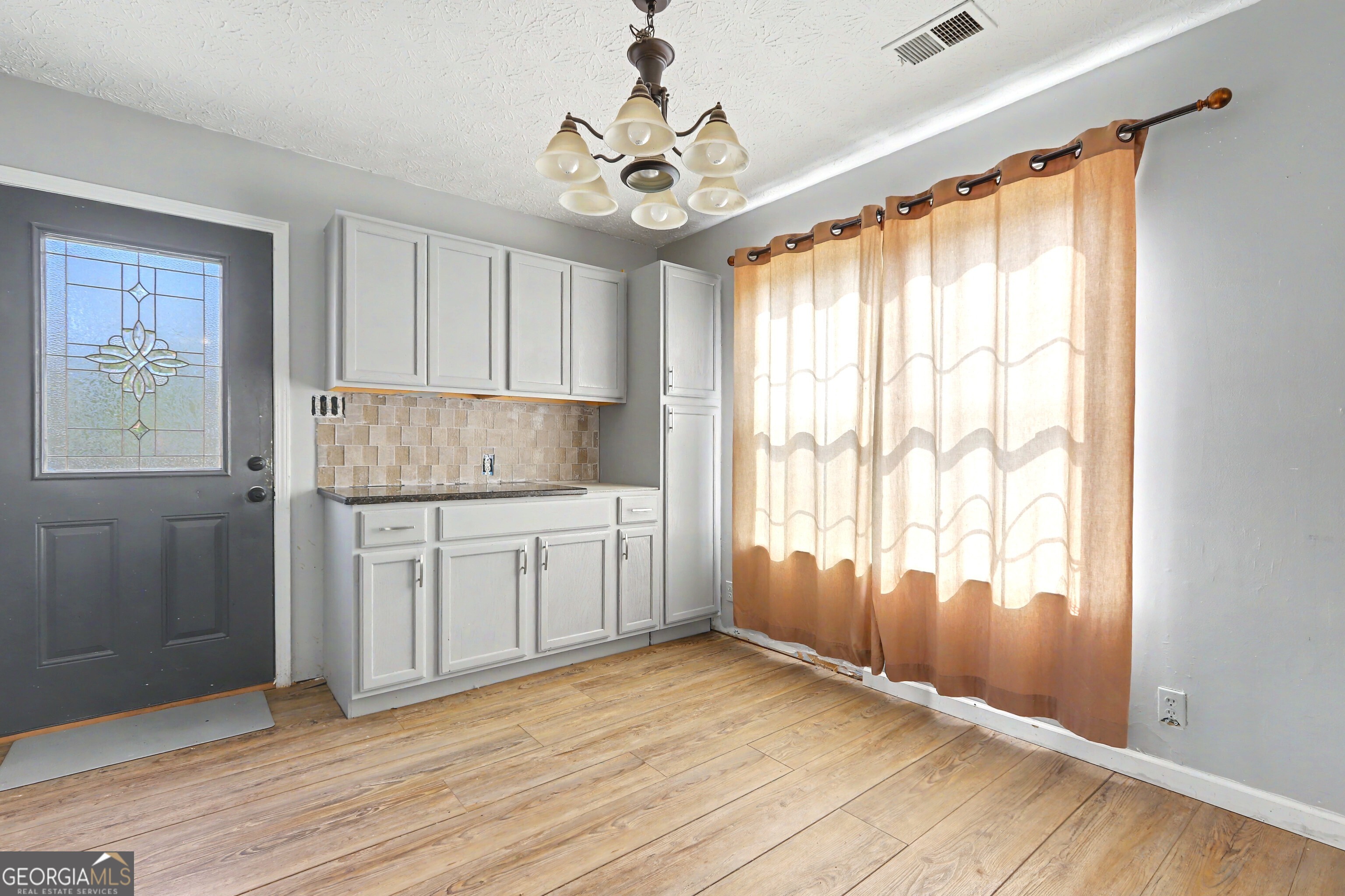 376 Doe Lane Mansfield, GA 30055 - Photo 13 of 28 a view of a kitchen with wooden floor and a window