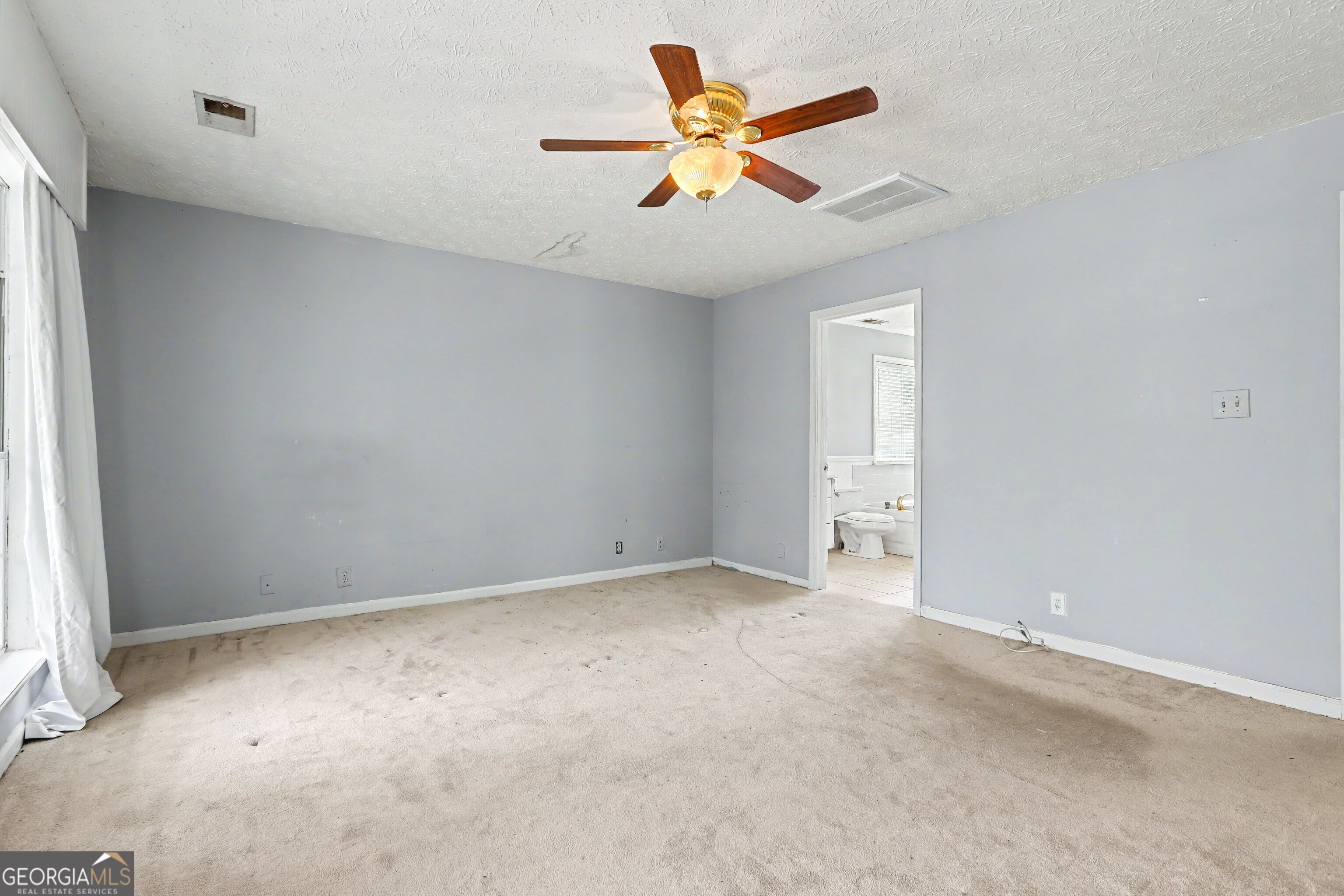 376 Doe Lane Mansfield, GA 30055 - Photo 16 of 28 an empty room with a window and a fan