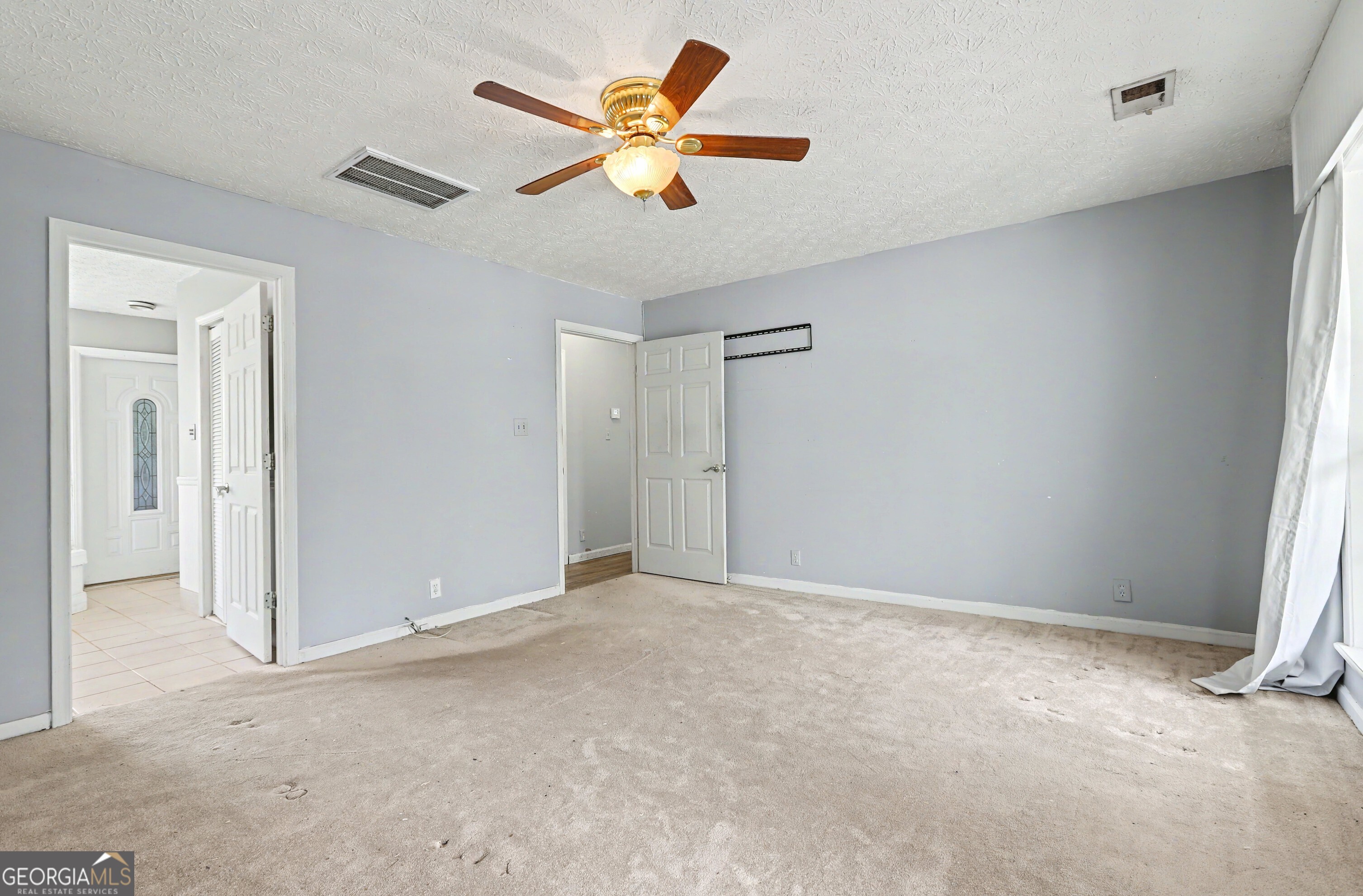376 Doe Lane Mansfield, GA 30055 - Photo 17 of 28 an empty room with closet and fan