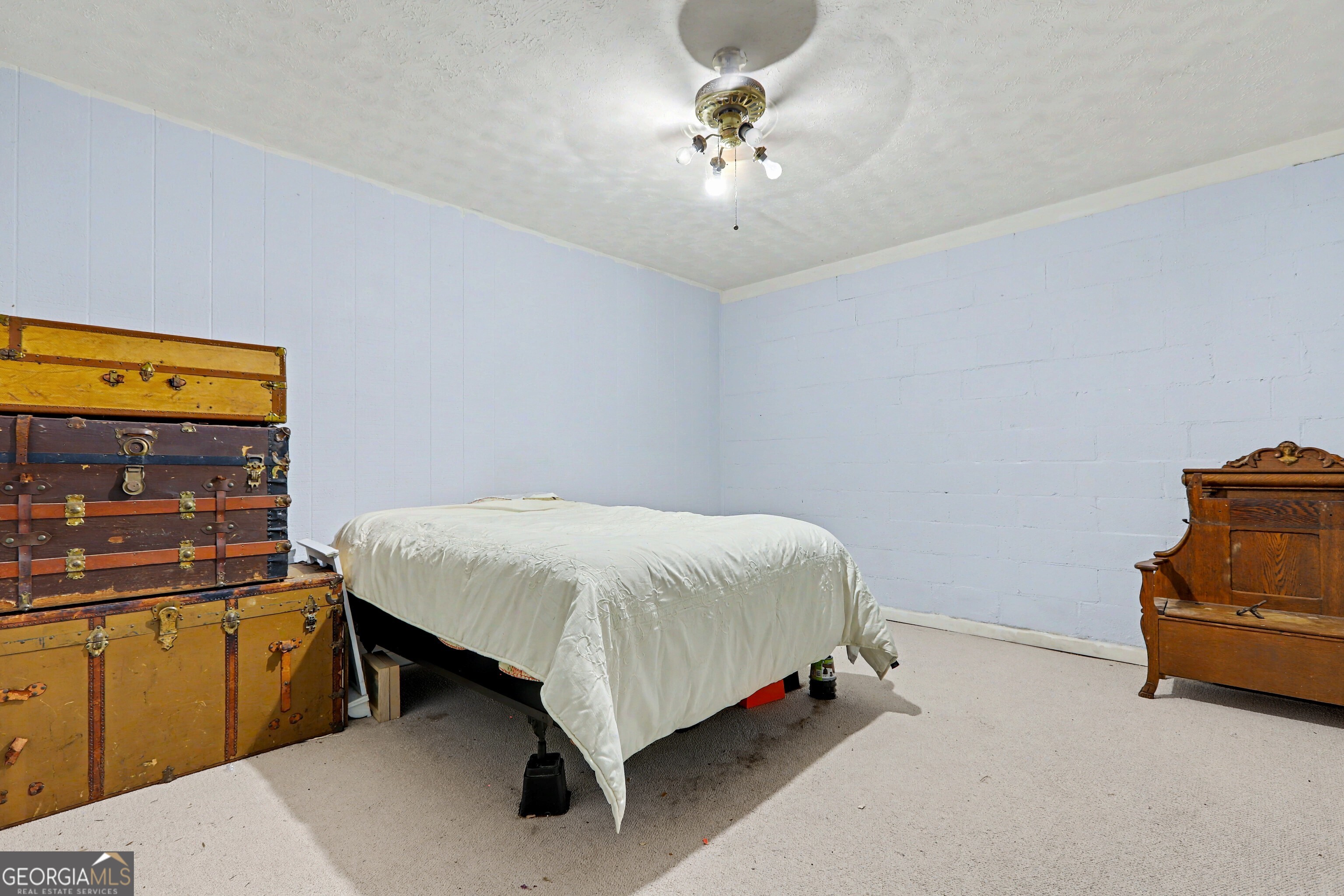 376 Doe Lane Mansfield, GA 30055 - Photo 26 of 28 a bed room with a bed and a chandelier