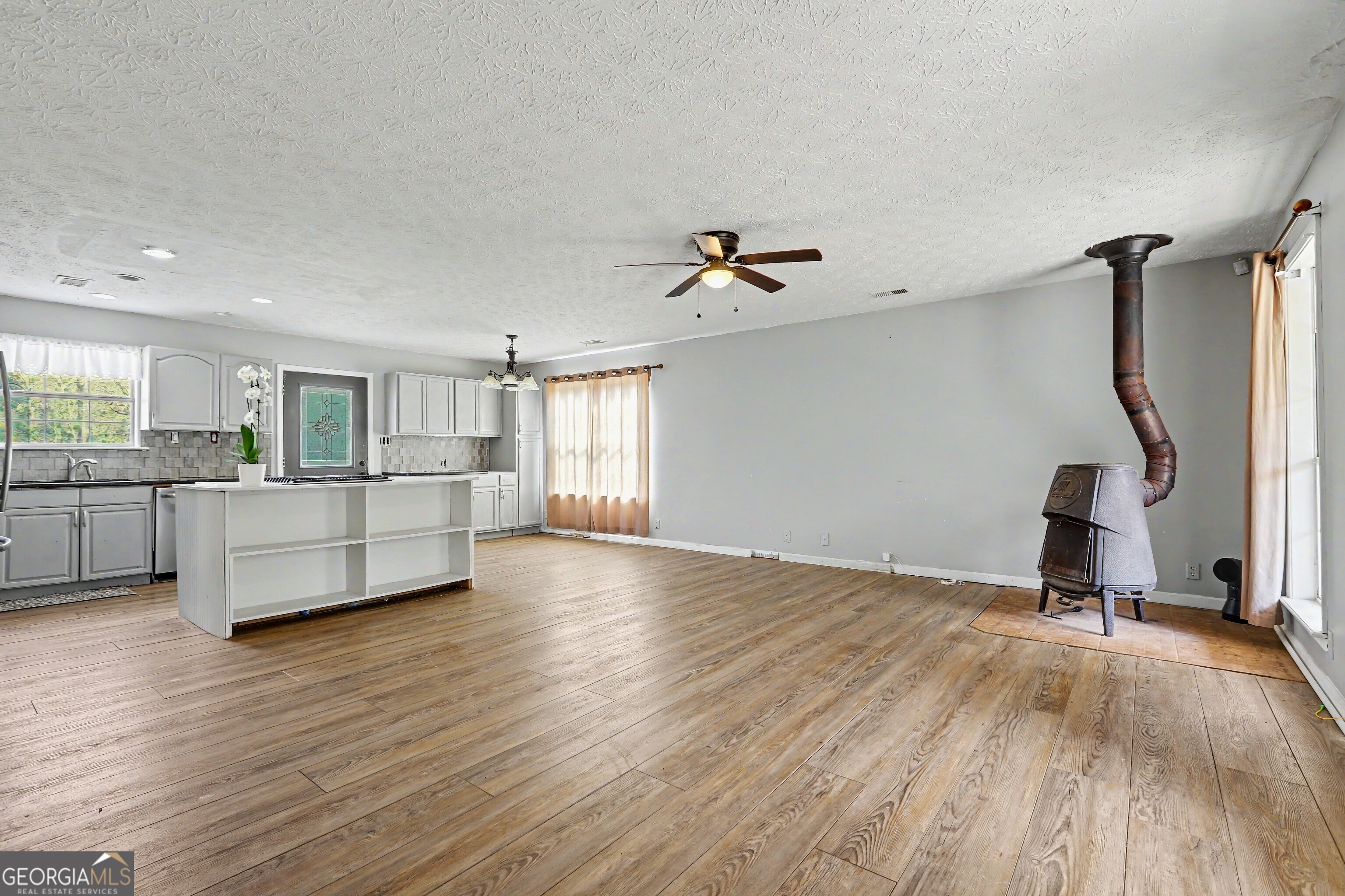 376 Doe Lane Mansfield, GA 30055 - Photo 4 of 28 a view of a kitchen with a sink and wooden floor