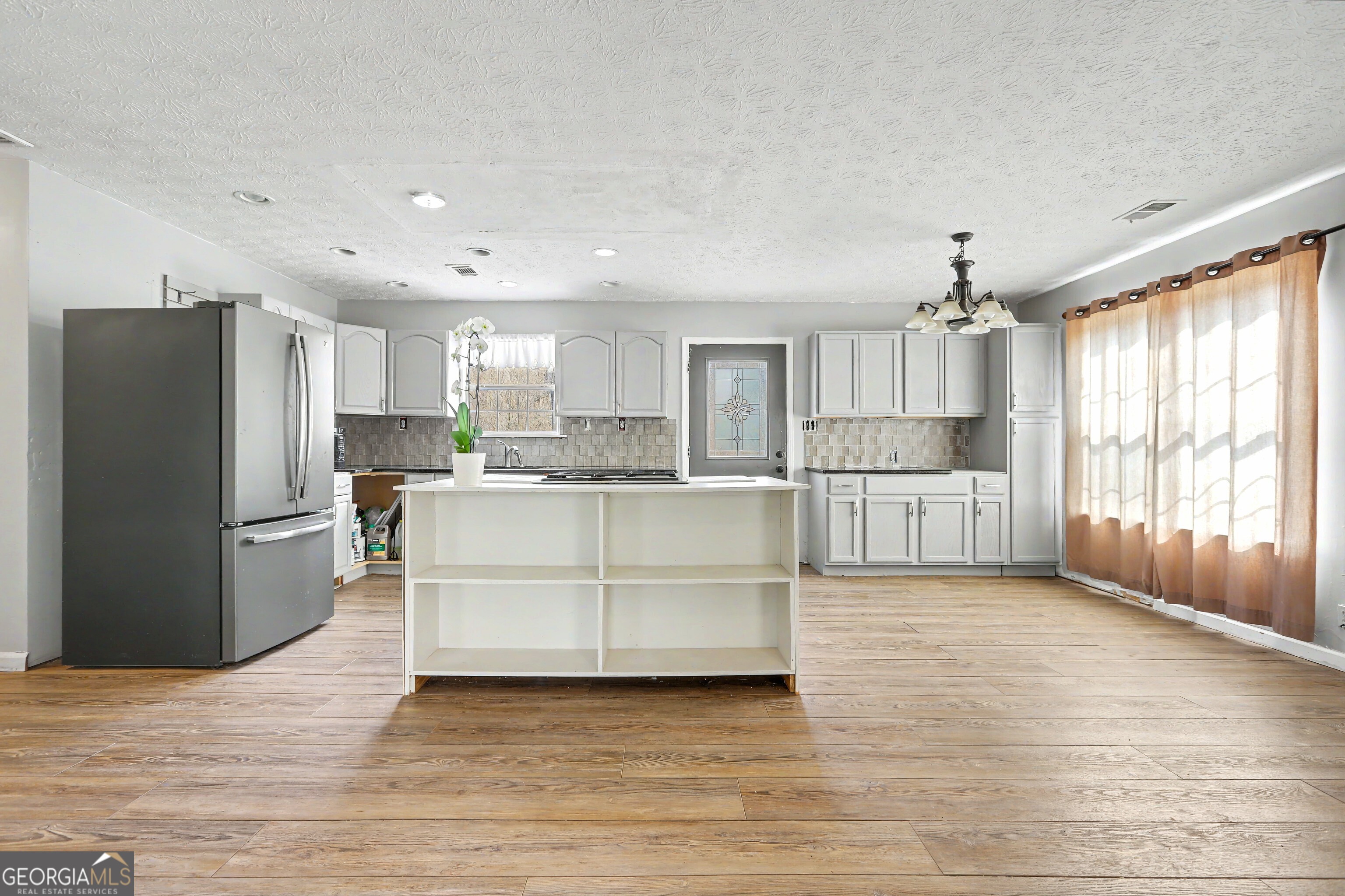 376 Doe Lane Mansfield, GA 30055 - Photo 9 of 28 a kitchen with a refrigerator and a sink