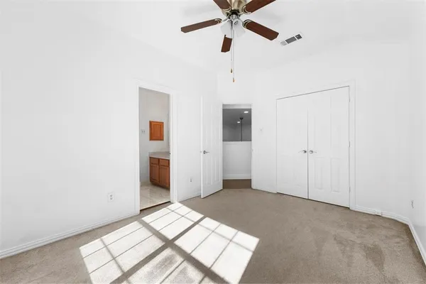 a view of a hallway with a chandelier fan