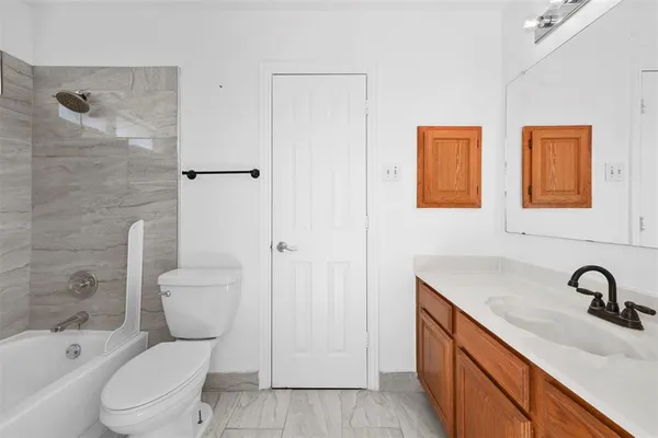 a white toilet sitting next to a bathroom sink
