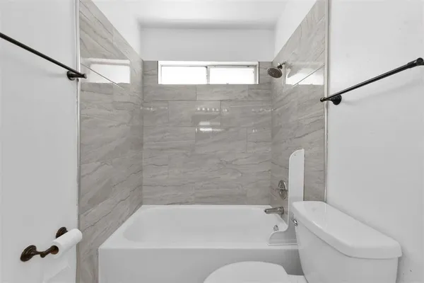 a bathroom with a bathtub and toilet