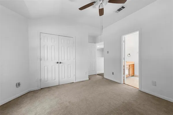 an empty room with closet area