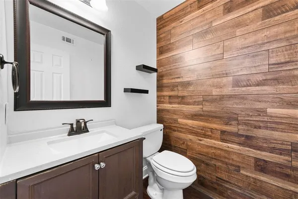 a bathroom with a sink toilet and mirror