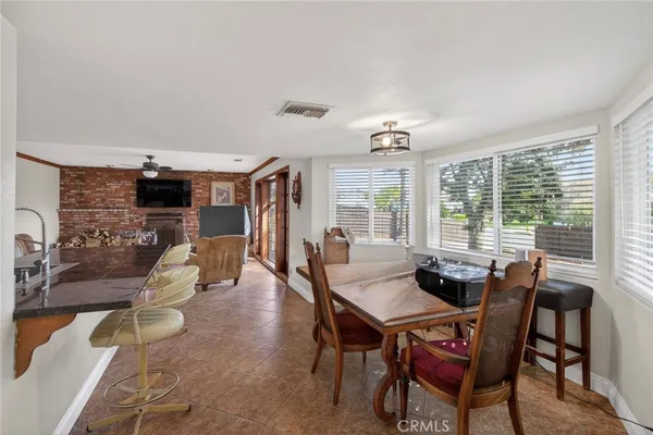 a dining room with furniture window and wooden floor