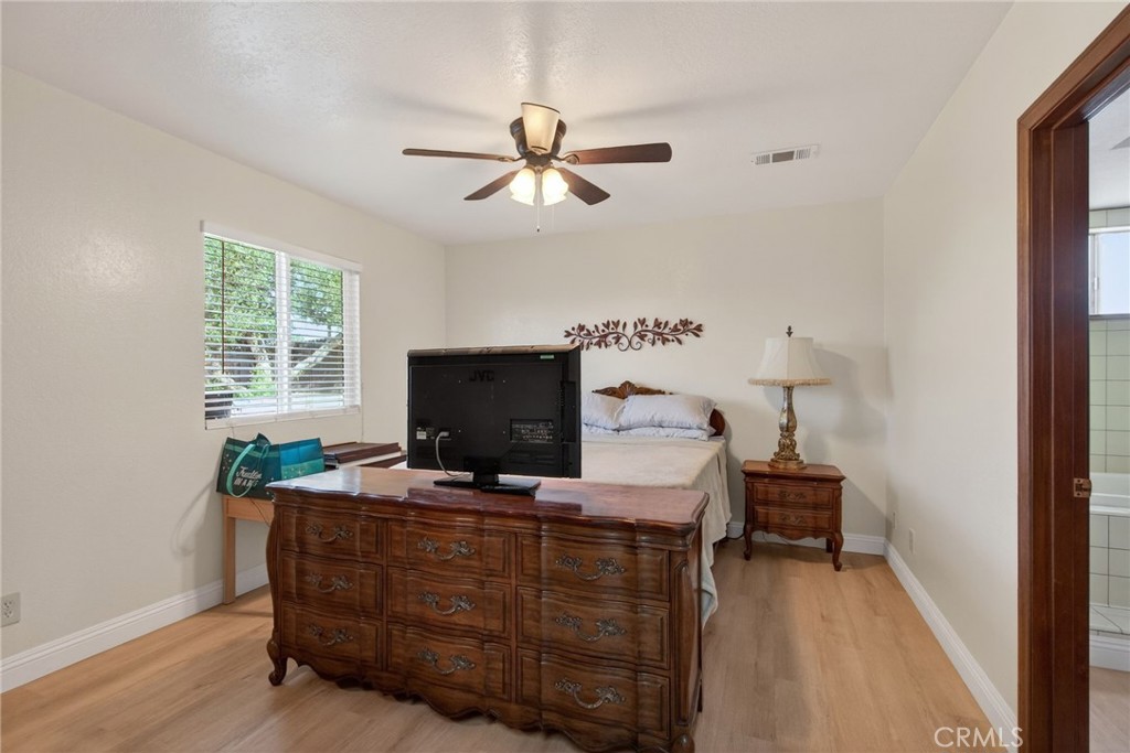 14435 Wood Road Riverside, CA 92508 - Photo 26 of 66 a living room with furniture and a flat screen tv
