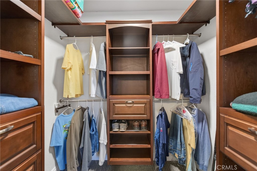 14435 Wood Road Riverside, CA 92508 - Photo 27 of 66 a view of walk in closet with clothes and shoes