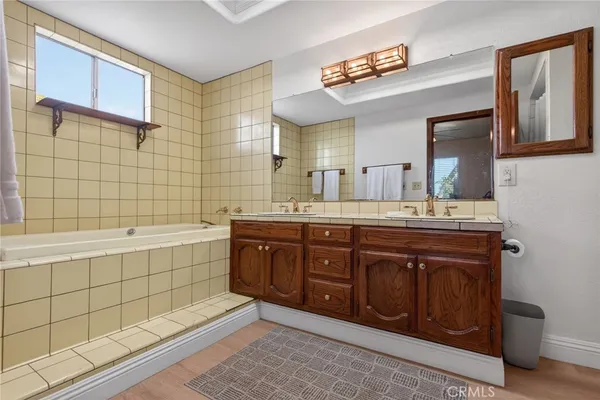 a bathroom with a sink toilet double vanity and shower