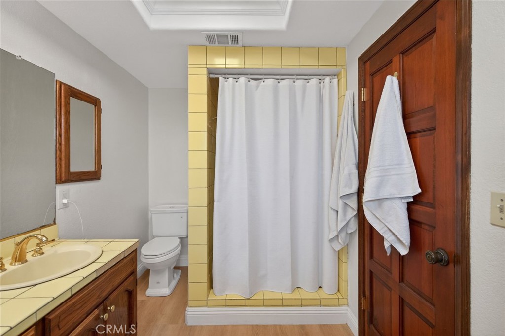 14435 Wood Road Riverside, CA 92508 - Photo 29 of 66 a bathroom with a sink a toilet and a window