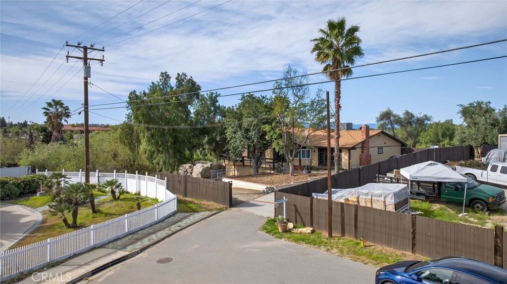 14435 Wood Road Riverside, CA 92508 - Photo 32 of 66 a front view of a house with a garden and sitting area