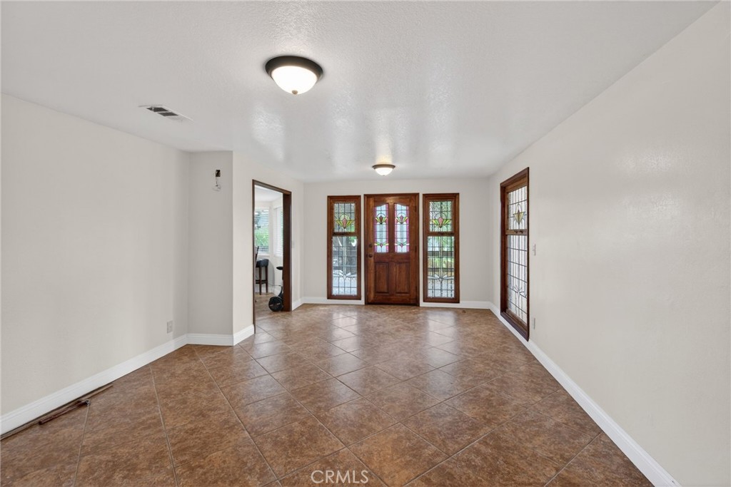 14435 Wood Road Riverside, CA 92508 - Photo 4 of 66 a view of an empty room with window and a kitchen