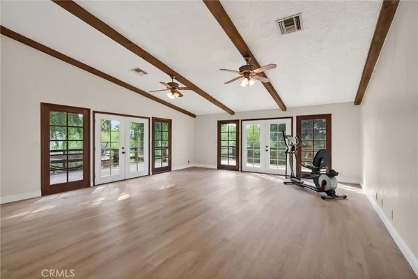 a view of a room with wooden floor and windows