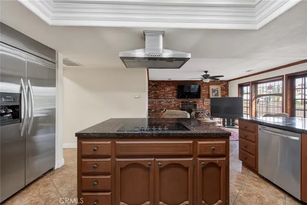 a kitchen with stainless steel appliances granite countertop a sink and cabinets